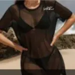 Person wearing a sheer black mesh top with visible black undergarments.
